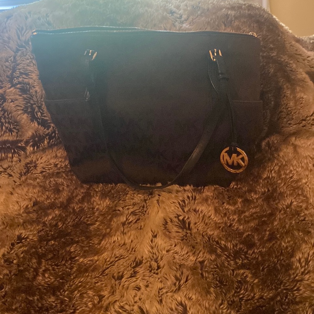 Michael Kors, dark brown and black, “MK” canvas bag with gold accents.